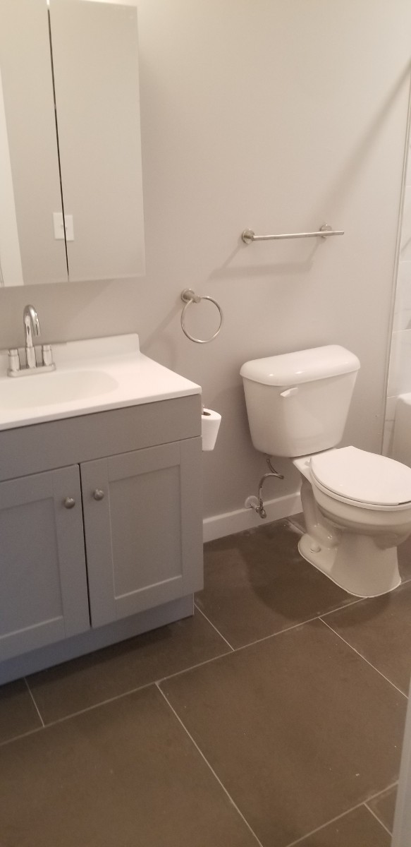 bathroom with white and grey counter and sink
