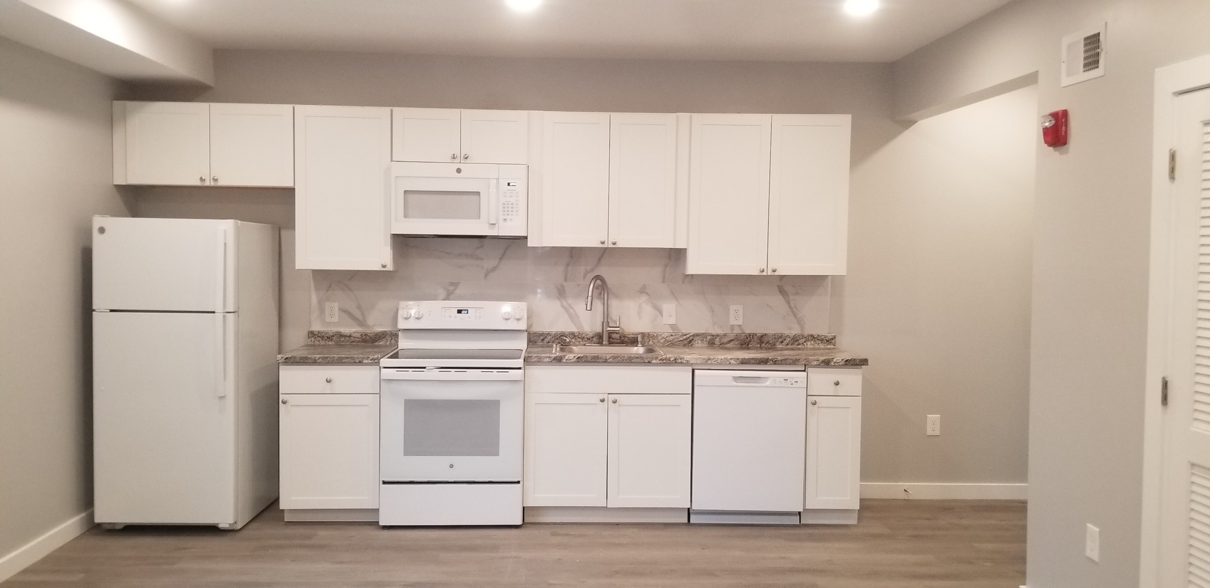 straight on view of whole kitchen with white appliances