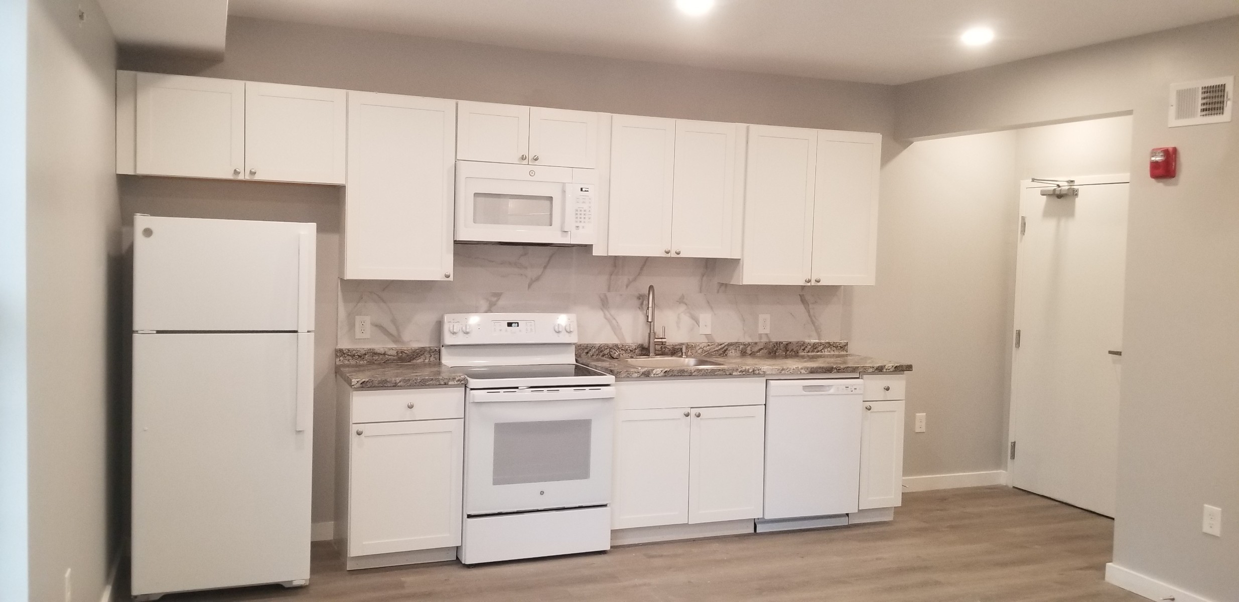 side view of whole kitchen with white appliances