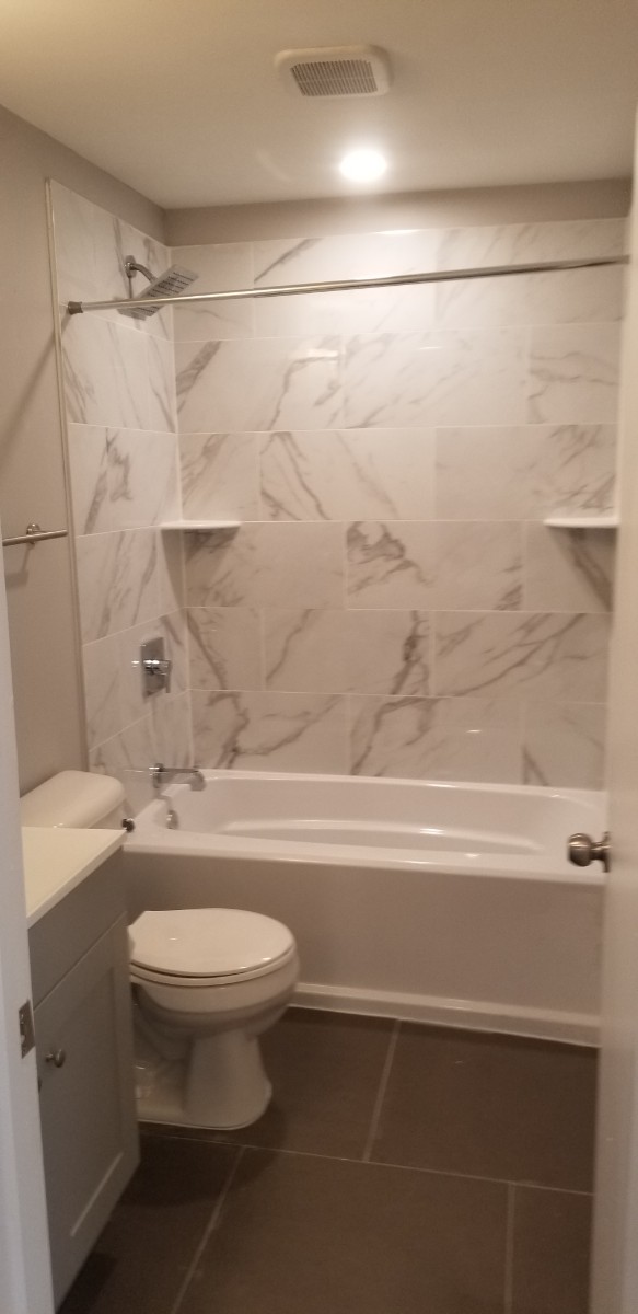 white and grey bathroom with tiled shower